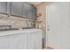 Bright laundry room featuring side-by-side washer and dryer and storage cabinets at 29915 N Maravilla Dr, San Tan Valley, AZ 85143