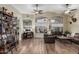 Spacious living room featuring wood-look floors, high ceilings, and large windows for abundant natural light at 29915 N Maravilla Dr, San Tan Valley, AZ 85143