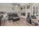 Comfortable living room featuring wood-look floors, high ceilings, and neutral paint, creating an inviting ambiance at 29915 N Maravilla Dr, San Tan Valley, AZ 85143