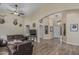 Inviting living room featuring wood-look floors, neutral paint, and high ceilings for a comfortable space at 29915 N Maravilla Dr, San Tan Valley, AZ 85143