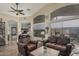Cozy living room with wood-look floors, neutral paint and large windows offering ample natural light at 29915 N Maravilla Dr, San Tan Valley, AZ 85143