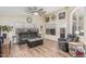 Spacious living room features wood floors, a ceiling fan, and plenty of natural light at 29915 N Maravilla Dr, San Tan Valley, AZ 85143