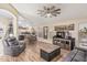 Open-concept living room with wood floors, neutral colors, and access to kitchen at 29915 N Maravilla Dr, San Tan Valley, AZ 85143