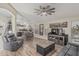 Spacious living room features ceiling fan, wood floors, and lots of seating for relaxing and entertaining guests at 29915 N Maravilla Dr, San Tan Valley, AZ 85143