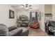 Cozy living room with sofa, chair, bookcase, and natural light at 29915 N Maravilla Dr, San Tan Valley, AZ 85143