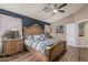 Spacious main bedroom with wood-look floors, ceiling fan, and ensuite bathroom at 29915 N Maravilla Dr, San Tan Valley, AZ 85143