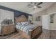Elegant main bedroom with a spacious bed, wood floors, and stylish nightstands for a comfortable retreat at 29915 N Maravilla Dr, San Tan Valley, AZ 85143