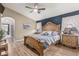 Spacious main bedroom with wood-look floors and ensuite bathroom at 29915 N Maravilla Dr, San Tan Valley, AZ 85143