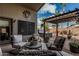 Outdoor patio with comfortable seating, pergola, hot tub, and desert landscaping at 29915 N Maravilla Dr, San Tan Valley, AZ 85143