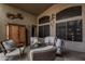 Covered patio featuring comfortable seating, decorative accents, and stylish outdoor furniture, ideal for relaxing and entertaining at 29915 N Maravilla Dr, San Tan Valley, AZ 85143
