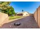 Wide backyard with space for activities, partially gravelled with a strip of green lawn, waiting for landscaping dreams at 3002 S Marigold Pl, Chandler, AZ 85248