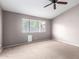 Cozy bedroom with a ceiling fan, neutral carpet, and window views at 3002 S Marigold Pl, Chandler, AZ 85248