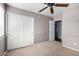 Bedroom with beige walls, carpet, a ceiling fan, and a closet, offering ample storage space and a comfortable retreat at 3002 S Marigold Pl, Chandler, AZ 85248