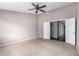 Bedroom showcasing a ceiling fan, neutral carpet, and access to the en suite bathroom at 3002 S Marigold Pl, Chandler, AZ 85248