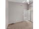 Neutral carpeted bedroom featuring a ceiling fan and access to an adjacent space, creating a light filled retreat at 3002 S Marigold Pl, Chandler, AZ 85248