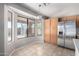 Bright breakfast nook featuring large windows, tiled floors, and stainless steel refrigerator at 3002 S Marigold Pl, Chandler, AZ 85248