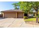 Front exterior view of this home featuring a tile roof, three-car garage and desert landscaping at 3002 S Marigold Pl, Chandler, AZ 85248