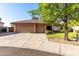 View of the home from the street featuring a tile roof, three-car garage and desert landscaping at 3002 S Marigold Pl, Chandler, AZ 85248