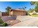 View of the three-car garage and a side-yard area with low maintenance desert landscaping at 3002 S Marigold Pl, Chandler, AZ 85248