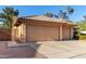 Exterior view of the three-car garage and low maintenance desert landscaping at 3002 S Marigold Pl, Chandler, AZ 85248