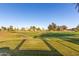 Scenic view of the golf course featuring lush green fairways, mature trees, and clear blue skies at 3002 S Marigold Pl, Chandler, AZ 85248