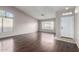 Spacious living room with dark laminate flooring, large windows and neutral walls at 3002 S Marigold Pl, Chandler, AZ 85248