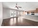Open concept living space featuring laminate flooring, a ceiling fan and an island with a breakfast bar at 3002 S Marigold Pl, Chandler, AZ 85248