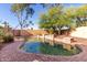 Private backyard pool area with natural stone and lush landscaping, perfect for relaxing swims and outdoor enjoyment at 3002 S Marigold Pl, Chandler, AZ 85248