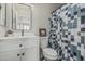 Well-lit bathroom featuring a modern vanity with storage and a decorative shower curtain at 3212 W Lucia Dr, Phoenix, AZ 85083