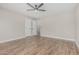 Inviting bedroom with wood-look floors, two closets, and a ceiling fan at 3212 W Lucia Dr, Phoenix, AZ 85083