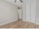 Bright bedroom featuring wood-look floors, neutral walls, and a large closet at 3212 W Lucia Dr, Phoenix, AZ 85083