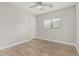 Bedroom with wood-look floors, neutral walls, ceiling fan, and a window with blinds at 3212 W Lucia Dr, Phoenix, AZ 85083