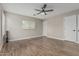 Well-lit bedroom showcasing wood-look floors, neutral walls, and a ceiling fan for added comfort at 3212 W Lucia Dr, Phoenix, AZ 85083