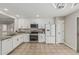 A well-equipped kitchen featuring white cabinetry, stainless steel appliances, and granite countertops at 3212 W Lucia Dr, Phoenix, AZ 85083