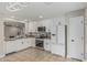 A well-equipped kitchen featuring white cabinetry, stainless steel appliances, and granite countertops at 3212 W Lucia Dr, Phoenix, AZ 85083