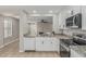 Modern kitchen featuring stainless steel appliances, granite countertops, and sleek white cabinetry at 3212 W Lucia Dr, Phoenix, AZ 85083