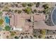 Bird's eye view of the property showcases the backyard pool, outdoor kitchen, and beautiful desert landscape at 3217 N Piedra Cir, Mesa, AZ 85207