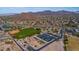 Community aerial view featuring a baseball field, sport courts, and ample parking at 3217 N Piedra Cir, Mesa, AZ 85207