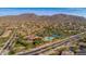 Aerial view showcases community amenities, surrounding landscape, and mountain views at 3217 N Piedra Cir, Mesa, AZ 85207