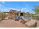 Backyard featuring pool, spa, seating, outdoor kitchen, and lush landscaping at 3217 N Piedra Cir, Mesa, AZ 85207
