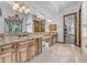 Elegant bathroom featuring a double vanity with granite countertops, mirrors, and lighting at 3217 N Piedra Cir, Mesa, AZ 85207