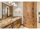 Bathroom features a single sink, wooden cabinetry, and a decorative mirror at 3217 N Piedra Cir, Mesa, AZ 85207