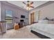 Bright bedroom features a ceiling fan, a window, and neutral carpet at 3217 N Piedra Cir, Mesa, AZ 85207