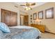 Comfortable bedroom features neutral colors, plush carpet, and shuttered windows for privacy and light control at 3217 N Piedra Cir, Mesa, AZ 85207