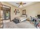 Bright bedroom features cozy carpet, an inviting bed, and an inviting workspace at 3217 N Piedra Cir, Mesa, AZ 85207