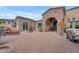 Elegant entrance courtyard with stone arch, water fountain, and inviting seating arrangements at 3217 N Piedra Cir, Mesa, AZ 85207