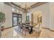Elegant dining room featuring a rustic chandelier and french doors that provide great lighting at 3217 N Piedra Cir, Mesa, AZ 85207