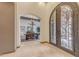 Arched entryway leads to dining room with chandelier and decorative iron door with beautiful hardware at 3217 N Piedra Cir, Mesa, AZ 85207