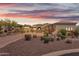 Desert landscaping surrounds this luxury home with an arched entryway and tile roof at 3217 N Piedra Cir, Mesa, AZ 85207