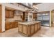 This gourmet kitchen has custom cabinets, an island with countertop seating, and stone accents at 3217 N Piedra Cir, Mesa, AZ 85207